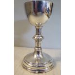 An Edwardian silver chalice, the cup shaped bowl with a gilded interior,
