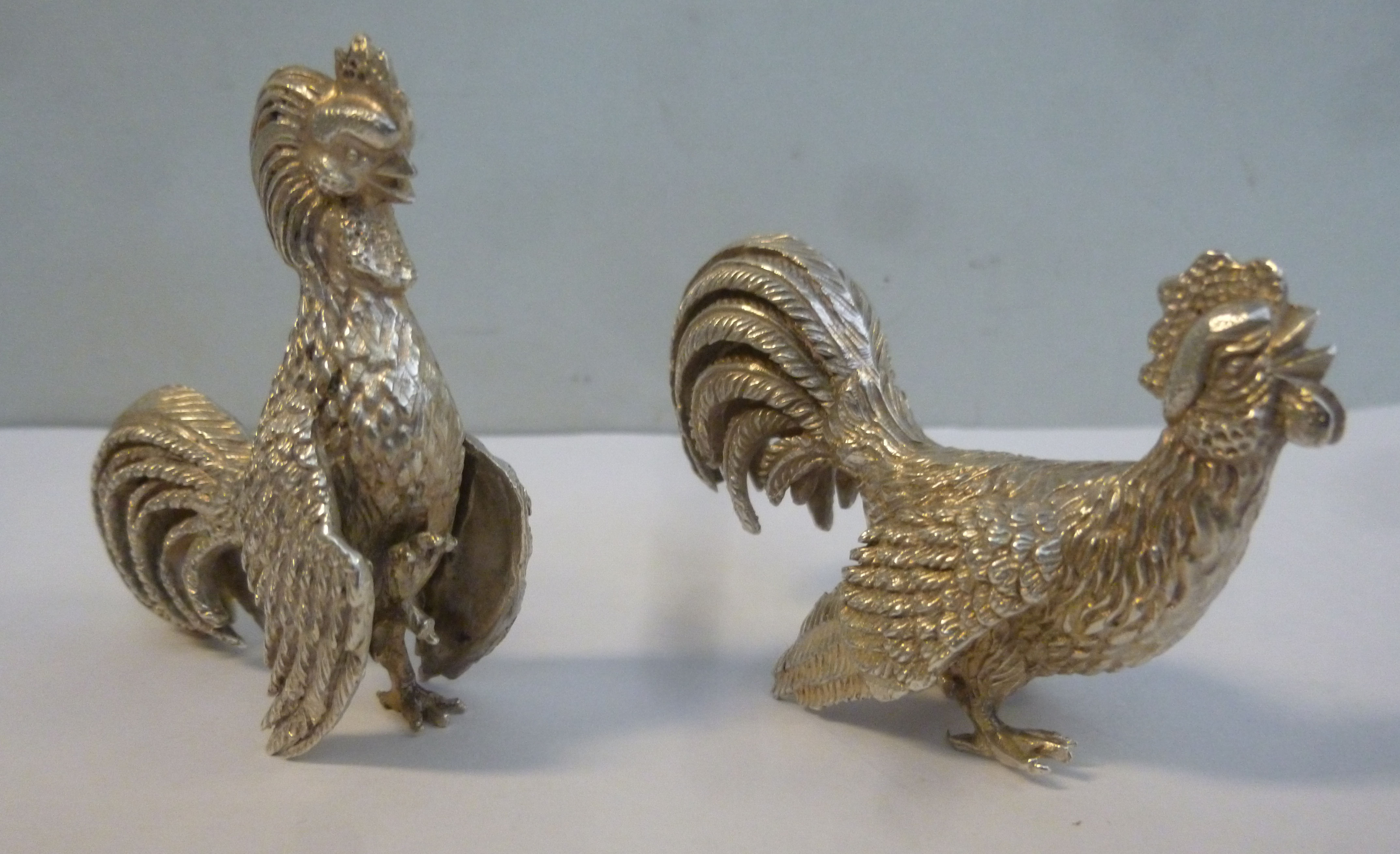 A pair of foreign white metal miniature models,