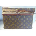 An early 20thC Louis Vuitton vanity case with a wooden frame and lined interior 9''h 12''w
