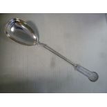 A white metal serving spoon, on a tapered,