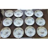 A set of twelve mid 19thC Continental moulded ivory glazed and gilded porcelain plates,
