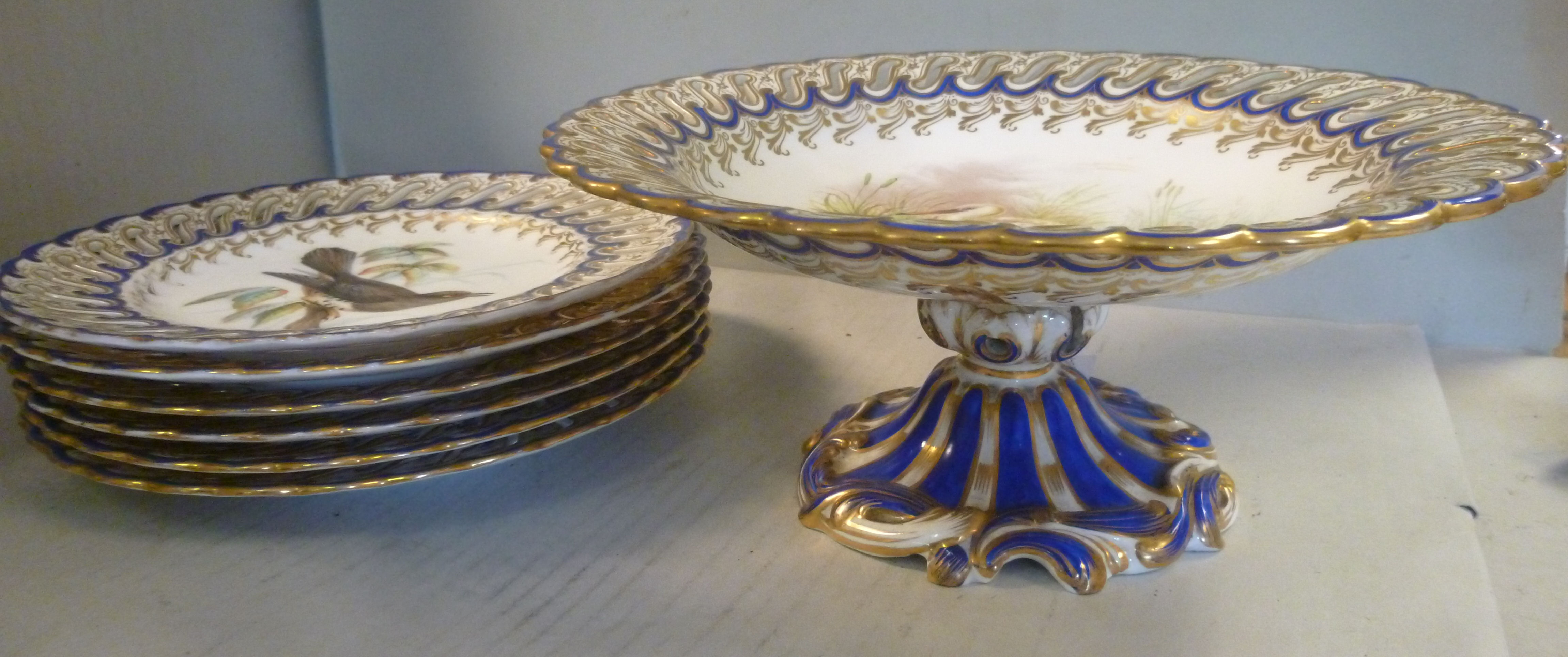 A set of six late 19thC china dessert plates and a matching comport with uniformly pierced and