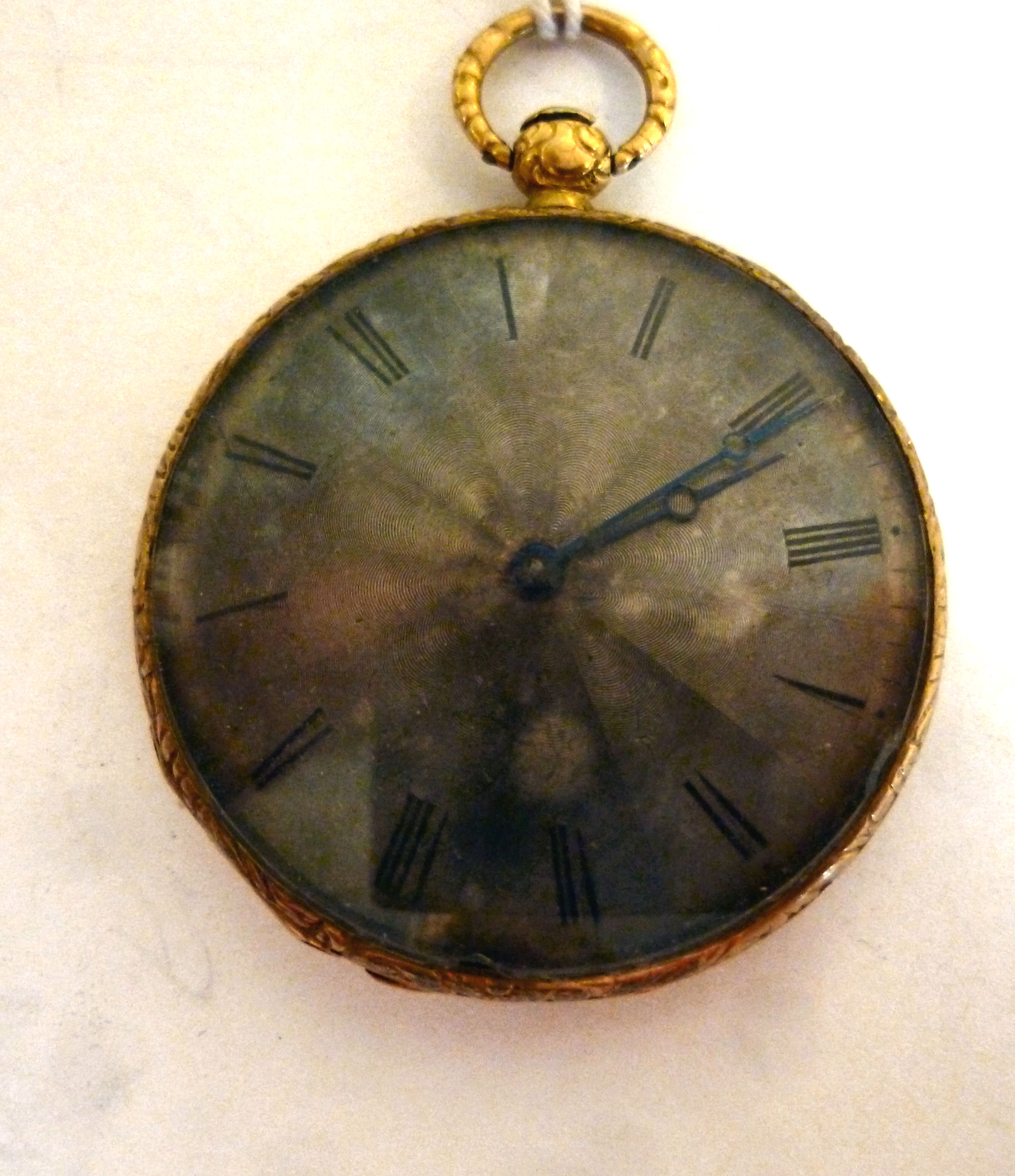 A late 19thC Flemish gold coloured metal slim cased pocket watch, engine turned,