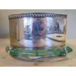 A late Victorian silver heart shaped box with a bevelled clear glass base,