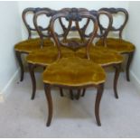 A set of six early Victorian foliate scroll carved rosewood framed balloon back dining chairs,