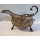 WITHDRAWN A silver sauce boat of shallow, circular form with a decoratively cut,