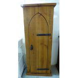 A modern CPW rough sawn planked pine cupboard with wrought iron fittings, the full height,