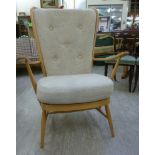 An Ercol pale beech framed Windsor style, high, round, spindled back, open arm chair,
