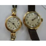 Two similar ladies 9ct gold round cased wristwatches, on hide straps, viz.