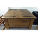 A modern CPW rough sawn planked pine coffee table with wrought iron fittings,