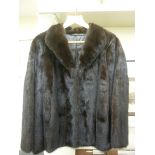 A dark brown mink fur jacket with a silk lining approx.