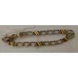 A silver and gold coloured metal flat link bracelet,