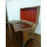 A Regency flame veneered mahogany and boxwood string inlaid sarcophagus design tea casket with cast