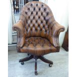 A modern desk chair of tub design, the stud and button upholstered in mid brown hide,