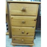 A modern waxed pine four drawer bedside cabinet,