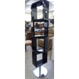 A modern black lacquered rotating display unit, fashioned as four cubes,