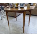 A mid 20thC mahogany D-end card table with a rear gate leg action, raised on stained beech,