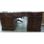 A modern burr walnut finished desk, the top set with a light brown hide scriber,