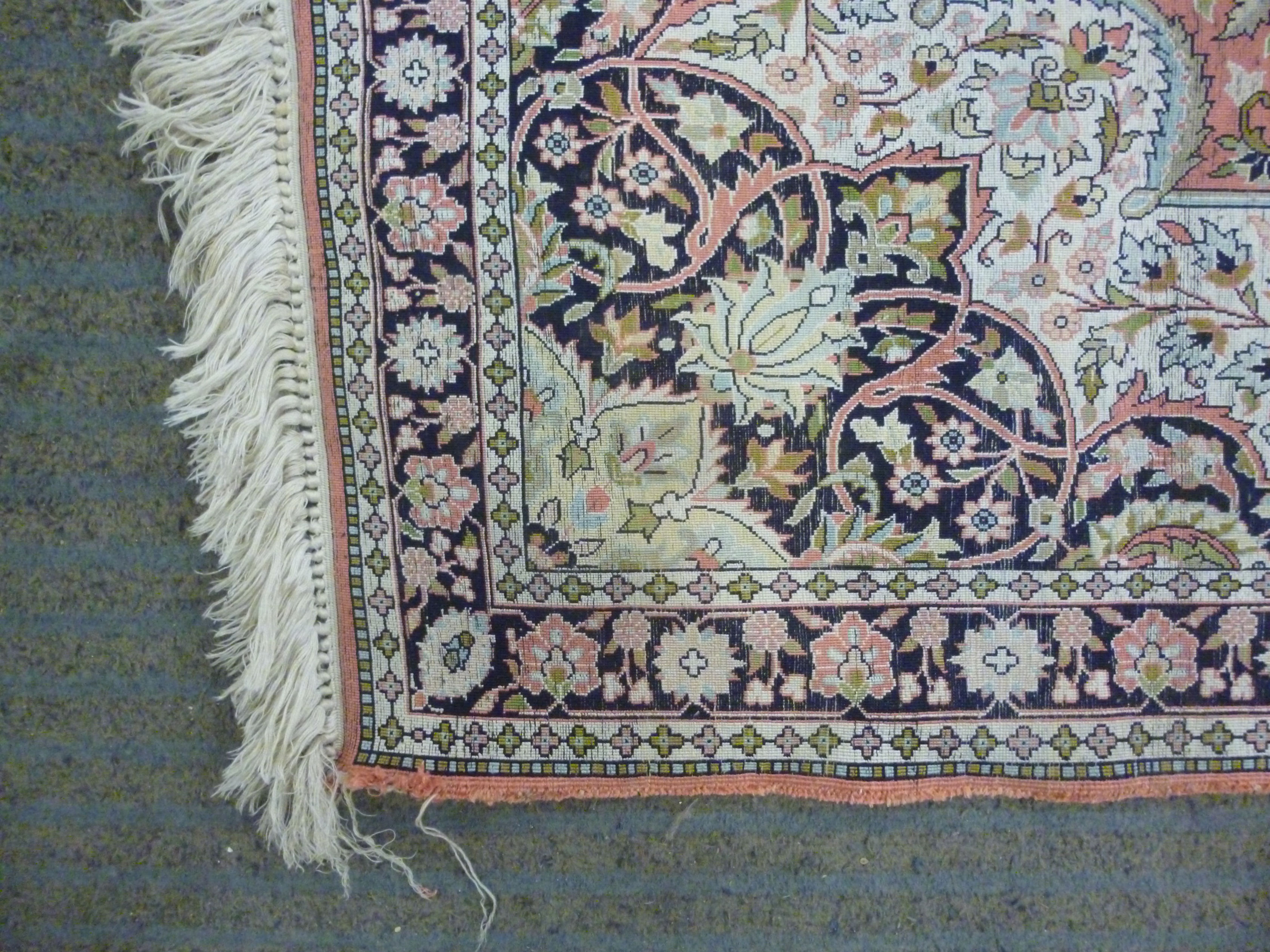 A modern silk rug with a central serpentine outlined medallion, bordered by flora and foliage, - Image 6 of 7