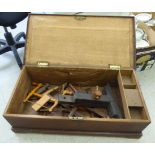 An early 20thC mahogany woodworker's tool chest with a hinged lid and straight sides,