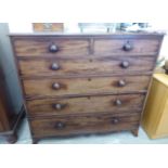 An early 19thC mahogany dressing chest with two short/four graduated long drawers,