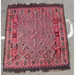 A Kelim rug with repeated diamond shaped motifs,