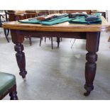 An early 20thC mahogany wind-out dining table, the top with rounded corners, raised on ring turned,