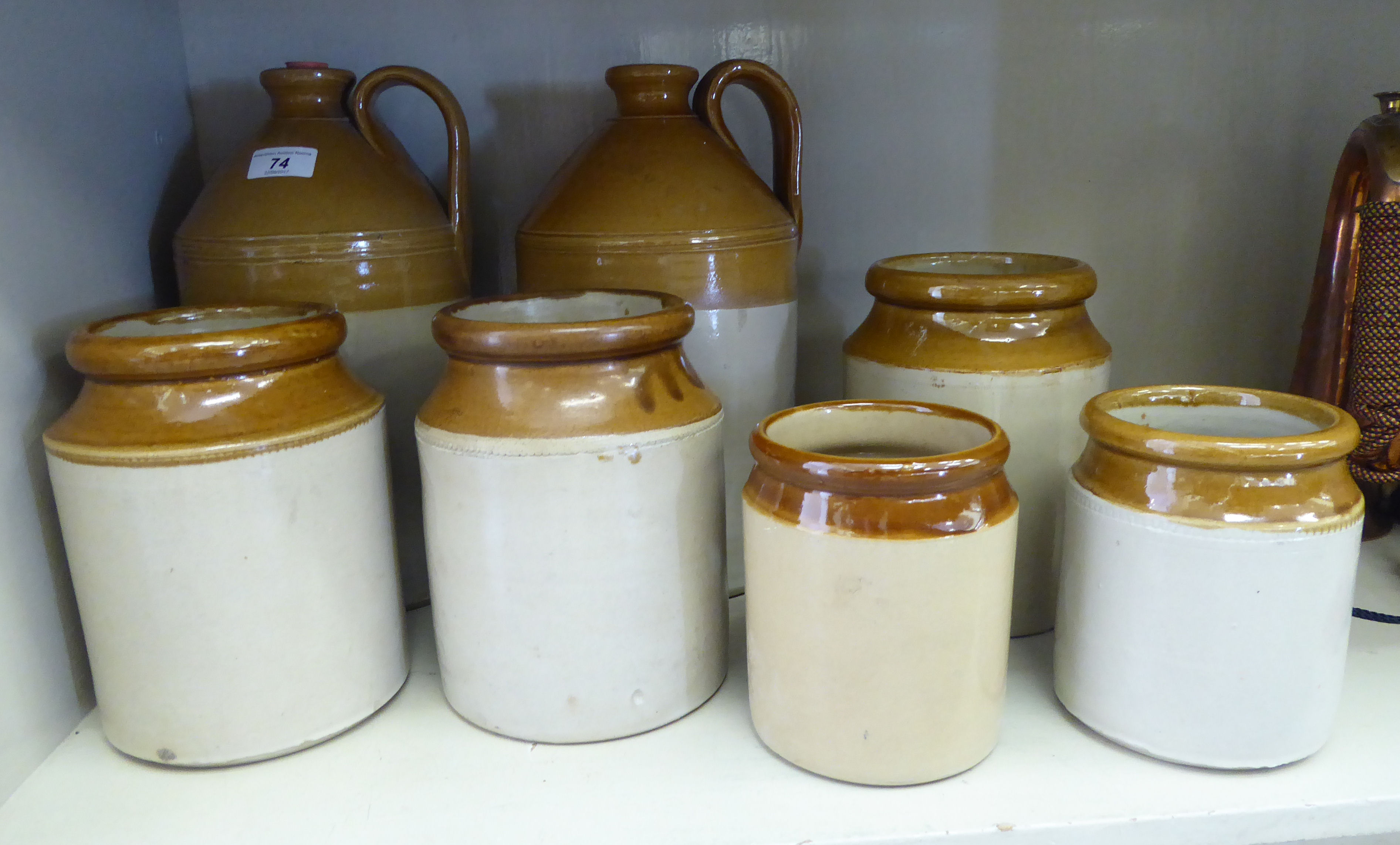 Late 19th/early 20thC two tone stoneware flagons and storage jars: to include one bearing a label