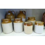 Late 19th/early 20thC two tone stoneware flagons and storage jars: to include one bearing a label