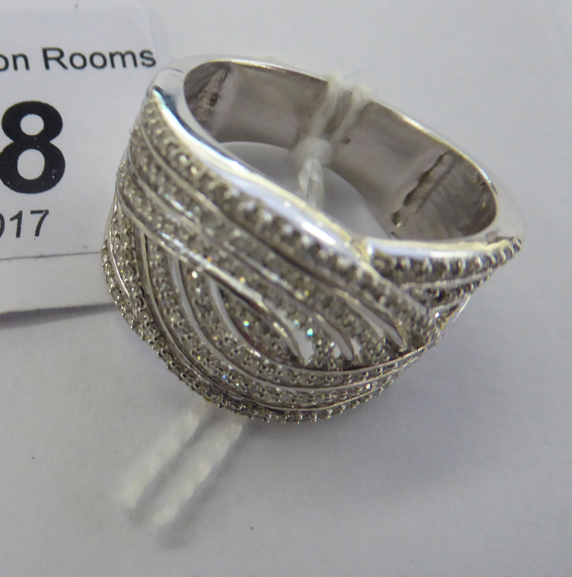 A 9ct white gold ring of free-flowing form,