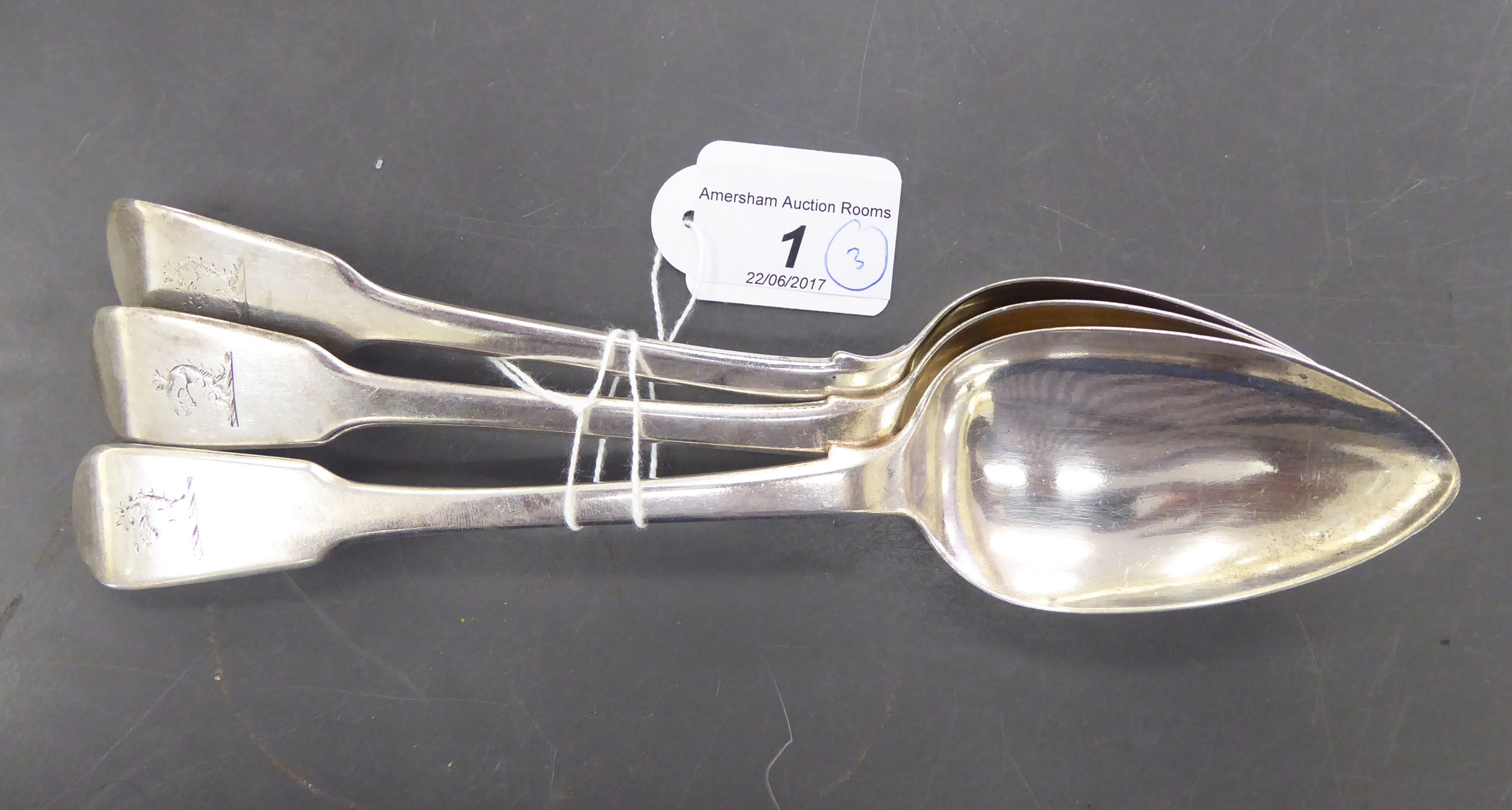 A matched set of three 19thC silver fiddle pattern table spoons mixed London marks CS