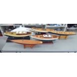 Five similar modern scratch built sailing boats,