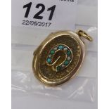 An 'antique' gold coloured metal locket with turquoise,