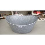 A modern aluminium twin handled planter of oval form 11''h 16''w RAB