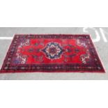 A central Persian rug with a serpentine outline medallion,