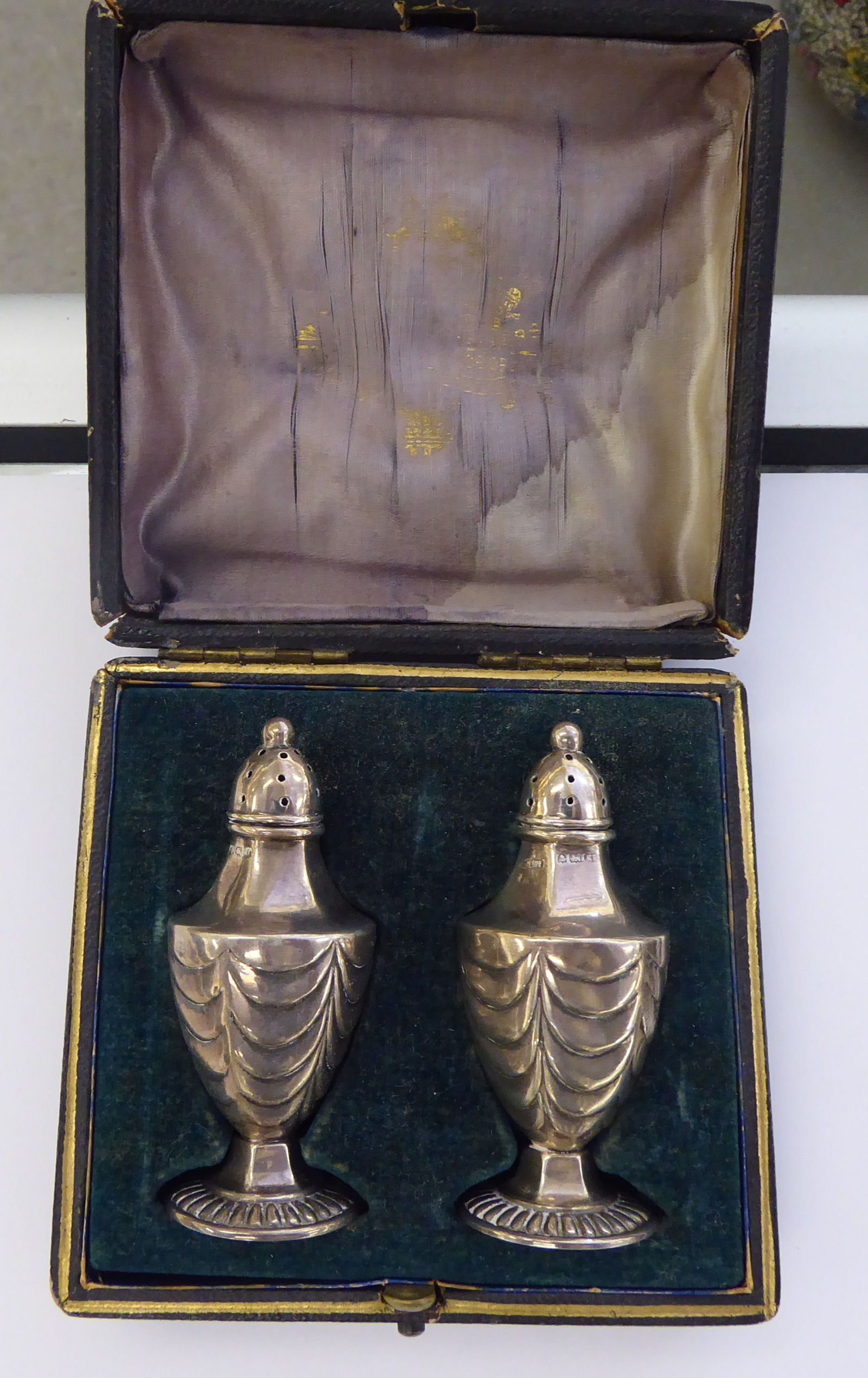 A pair of Edwardian silver pepper pots of tapered,