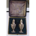 A pair of Edwardian silver pepper pots of tapered,