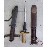 Three reproduction daggers: to include one with a brown hide handle stamped US M3 the blade 6.