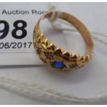 A 9ct gold ring, set with a central sapphire,