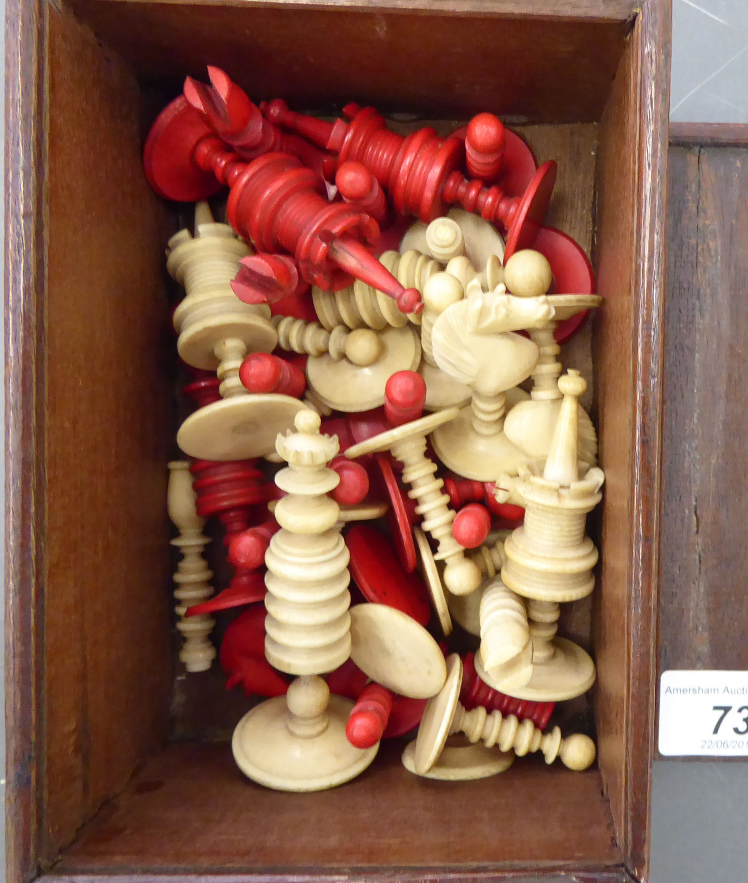 A late 19thC turned and stained ivory chess set (one Bishop missing,