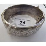 A mid 20thC silver bangle with foliate engraved ornament Birmingham 1960 11