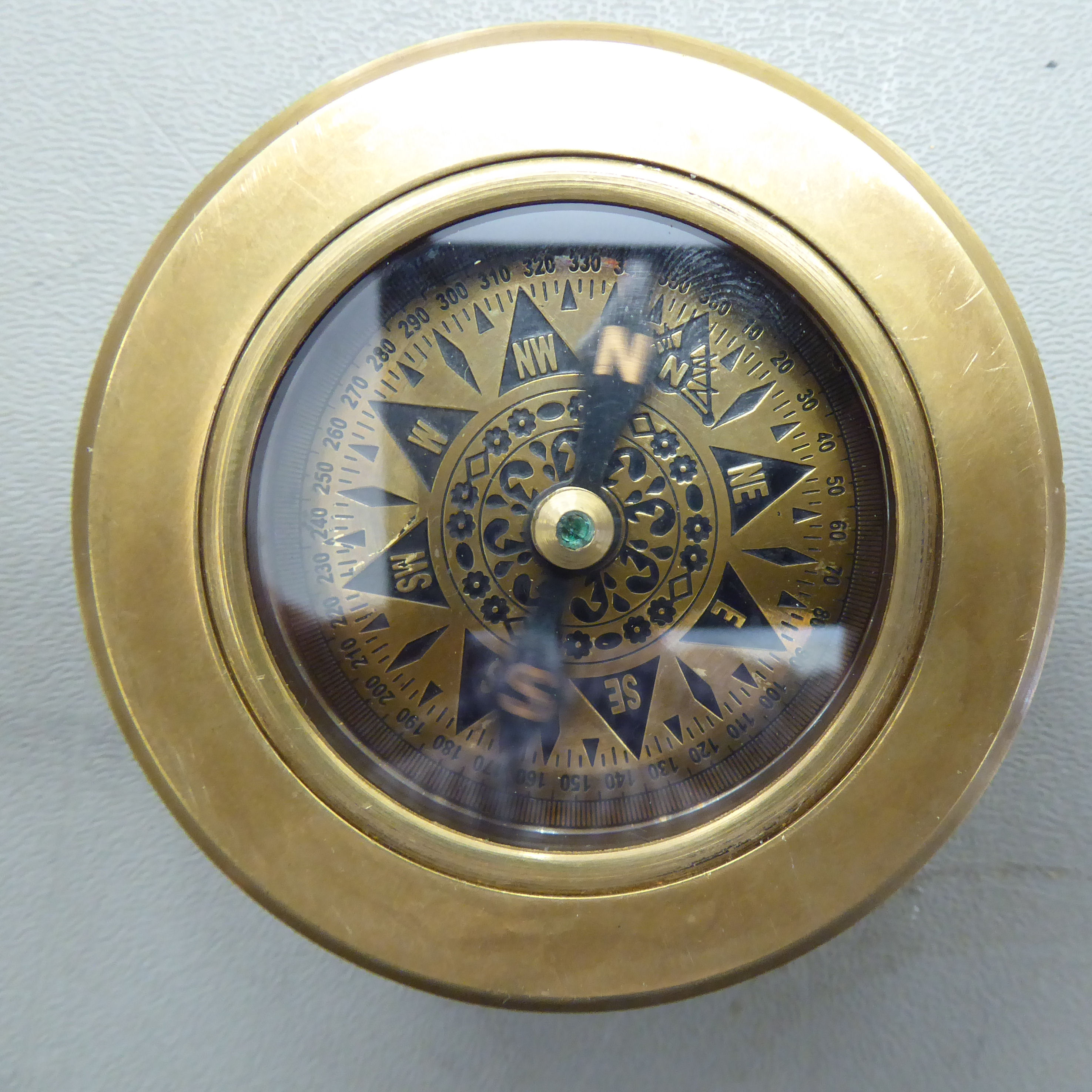 A modern brass combination compass/magnifying glass 2.