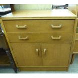 A mid 20thC G-Plan teak sideboard with two long drawers, over a pair of doors,