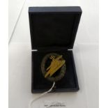 A reproduction of a cast metal German Luftwaffe paratrooper breast badge stamped CF Junker boxed