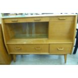 A mid 20thC G-Plan teak sideboard with an arrangement of glazed and panelled doors,