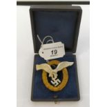 A reproduction of a cast metal German Luftwaffe pilot/observer breast badge stamped OG boxed