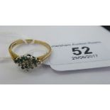 A 9ct gold emerald and diamond set cluster ring 11