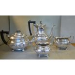 An Edwardian silver four piece tea set of oval, ogee,