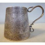 An early 20thC Asian silver coloured metal mug of tapered cylindrical form with a scrolled serpent