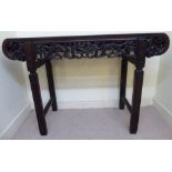 An early 20thC Chinese fruitwood altar table, the top set with a burr veneered panel,